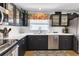 Modern kitchen featuring dark cabinets, stainless steel appliances, and a functional layout at 24055 Buckingham Way, Punta Gorda, FL 33980