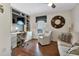 Office featuring a built-in desk, shelving, a comfortable chair, and hardwood floors at 24055 Buckingham Way, Punta Gorda, FL 33980