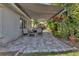 Spacious paved patio with outdoor furniture and awning, perfect for entertaining or relaxing at 24055 Buckingham Way, Punta Gorda, FL 33980