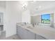 Spacious bathroom with dual sinks, quartz countertop, and large mirror at 24166 Colima Ct, Punta Gorda, FL 33955