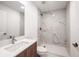 Modern bathroom boasts a walk-in shower with decorative tile, quartz countertop, and updated fixtures at 24166 Colima Ct, Punta Gorda, FL 33955