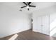Bedroom featuring hardwood floors, ceiling fan, and walk in closets at 24166 Colima Ct, Punta Gorda, FL 33955