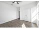 Bright bedroom features wood-look tile flooring, a ceiling fan, and a double-door closet at 24166 Colima Ct, Punta Gorda, FL 33955