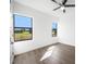 Light-filled bedroom with hardwood floors and large windows showcasing picturesque views at 24166 Colima Ct, Punta Gorda, FL 33955