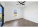 This bright bedroom offers a large window, wood-look tile flooring, and ample natural light at 24166 Colima Ct, Punta Gorda, FL 33955