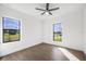 Bedroom with hardwood floors, black ceiling fan, and natural light at 24166 Colima Ct, Punta Gorda, FL 33955
