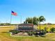 Welcome to Burnt Store Lakes, a deed-restricted community with lush landscaping and an American flag at 24166 Colima Ct, Punta Gorda, FL 33955