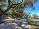 Scenic park view with walking path, seating, and lush landscaping by the lake at 24166 Colima Ct, Punta Gorda, FL 33955