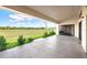 A covered patio offers a peaceful outdoor space with views of the lush green landscape at 24166 Colima Ct, Punta Gorda, FL 33955
