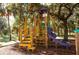 Fun playground with climbing structure, slide, and playful green, yellow, and purple color scheme at 24166 Colima Ct, Punta Gorda, FL 33955