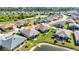 Aerial view of home in a golf community with pond, mature landscaping, and a location marker at 24371 Westgate Blvd, Port Charlotte, FL 33980