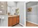 Bathroom with granite counters, wooden cabinets, and a large mirror at 24371 Westgate Blvd, Port Charlotte, FL 33980