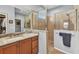 Bathroom featuring granite vanity, glass shower, and walk-in closet at 24371 Westgate Blvd, Port Charlotte, FL 33980