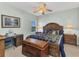 Bedroom featuring a decorative ceiling fan, a trunk, and a comfy bed with matching furnishings at 24371 Westgate Blvd, Port Charlotte, FL 33980