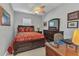Bedroom with a dark wood bed, large dresser, desk and chair, and ceiling fan at 24371 Westgate Blvd, Port Charlotte, FL 33980