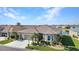 Well-kept home featuring a two-car garage, meticulous landscaping, and a serene pond view in a tranquil neighborhood at 24371 Westgate Blvd, Port Charlotte, FL 33980