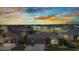 Beautiful exterior view of home with a well-manicured lawn, two-car garage, and serene water view at sunset at 24371 Westgate Blvd, Port Charlotte, FL 33980