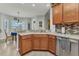 Kitchen with granite counters, stainless steel appliances, wood cabinetry and adjacent dining area at 24371 Westgate Blvd, Port Charlotte, FL 33980