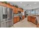 Open kitchen with stainless steel appliances, wood cabinets, granite counters, and tile backsplash at 24371 Westgate Blvd, Port Charlotte, FL 33980
