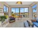 Bright sunroom with views of a lake, neutral walls, modern ceiling fan, and cozy furniture at 24371 Westgate Blvd, Port Charlotte, FL 33980