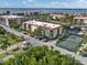 Aerial view of a community featuring manicured landscaping, beautiful waterways, and a tennis court at 25188 Marion Ave # 1013, Punta Gorda, FL 33950