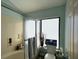 Bathroom with combined tub and shower featuring a frosted glass sliding door next to a window at 25188 Marion Ave # 1013, Punta Gorda, FL 33950