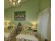 Stylish bedroom with two twin beds, chandelier and tasteful decor at 25188 Marion Ave # 1013, Punta Gorda, FL 33950