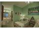 Bright bedroom featuring twin beds, green walls, and an adjacent bathroom at 25188 Marion Ave # 1013, Punta Gorda, FL 33950