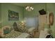 Cozy bedroom featuring twin beds, ample natural light, and vibrant decor at 25188 Marion Ave # 1013, Punta Gorda, FL 33950