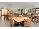 Bright dining area with tile floors, multiple tables and chairs, and plenty of natural light at 25188 Marion Ave # 1013, Punta Gorda, FL 33950