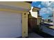 Garage and front entry featuring a wooden porch and stairs of a well-maintained townhome at 25188 Marion Ave # 1013, Punta Gorda, FL 33950