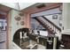 Kitchen area featuring granite countertops and an adjacent staircase at 25188 Marion Ave # 1013, Punta Gorda, FL 33950