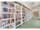 View of a library featuring floor-to-ceiling white bookshelves at 25188 Marion Ave # 1013, Punta Gorda, FL 33950