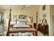 Charming main bedroom featuring a four-poster bed and stylish furnishings at 25188 Marion Ave # 1013, Punta Gorda, FL 33950