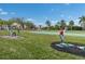 View of the community putting green, showcasing meticulous landscaping and recreational amenities at 25188 Marion Ave # 1013, Punta Gorda, FL 33950