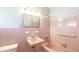 This bathroom features pink tiling and a vintage style sink and bathtub at 2548 Starlite Ln, Port Charlotte, FL 33952
