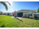 Lush backyard with well-kept lawn and brick patio featuring outdoor seating for relaxation at 27002 Clear Creek Way, Punta Gorda, FL 33950