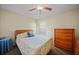 Guest bedroom with neutral walls, a ceiling fan and light-colored bedding at 27002 Clear Creek Way, Punta Gorda, FL 33950