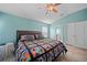 Bedroom with large bed, colorful quilt, and vaulted ceilings, next to bathroom at 27002 Clear Creek Way, Punta Gorda, FL 33950