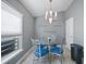Cozy eat-in kitchen with modern chandelier over glass-top table and a view of the window at 27002 Clear Creek Way, Punta Gorda, FL 33950