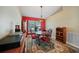 Cozy dining room is accented with red wall, chandelier and decorative rug at 27002 Clear Creek Way, Punta Gorda, FL 33950