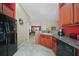 Bright eat-in kitchen with modern appliances, ample countertop space, and view of the dining room at 27002 Clear Creek Way, Punta Gorda, FL 33950