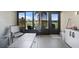 Enclosed lanai featuring neutral flooring, fan, and an outdoor lake view at 27002 Clear Creek Way, Punta Gorda, FL 33950