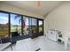 Enclosed lanai space with a lake view, ceiling fan, and neutral flooring at 27002 Clear Creek Way, Punta Gorda, FL 33950