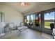 Relaxing lanai with seating overlooking a serene lake view and lush landscaping at 27002 Clear Creek Way, Punta Gorda, FL 33950