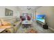 Comfortable living room featuring a plush sofa, two armchairs, and a large television for relaxation at 27002 Clear Creek Way, Punta Gorda, FL 33950