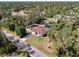 Aerial shot showcases manicured lawn, mature trees and a fenced backyard complete with storage shed at 3172 Sikeston Ave, North Port, FL 34286