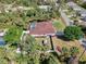 Aerial view of a fenced-in home with a screened pool and lush landscaping at 3172 Sikeston Ave, North Port, FL 34286