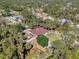 Overhead view of home shows manicured lawn, pool, and a lush, green landscape with mature trees and shrubs at 3172 Sikeston Ave, North Port, FL 34286