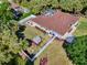 Aerial view of a fenced-in home with a screened pool and lush landscaping at 3172 Sikeston Ave, North Port, FL 34286